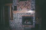Open fireplace in a bathhouse (sauna)  with a cast iron stove and a heated wall - 2004